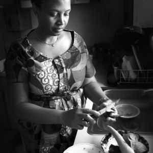 In 1998, Massan Dessou and her family arrived from the country of Togo, in Africa. Shown here in 2013 preparing dinner for her family, Massan was excited about becoming an American citizen and going back to school, she now holds a master's degree.