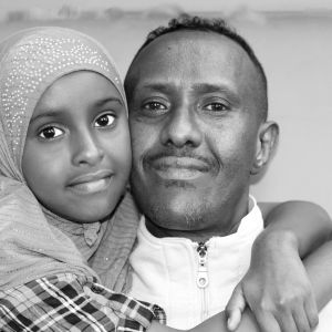 Khadija gives her father, Mohamed Abdi, a big hug. Abdi fled war-torn Somalia with his wife, Khadro, only to endure nearly a decade of hardship in an Ethiopian refguee camp, where Khadija, was born. The family ran a restaurant in Portland called Alleamin until high rent forced it to close.