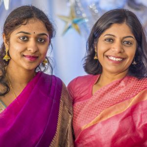 Members of a family of Indian immigrants smile during a traditional godh bharai celebration (a baby shower). Godh bharai literally means "to fill the lap." The ceremony often includes dressing the expectant mother with jewelry and "filling her lap" with gifts and food.